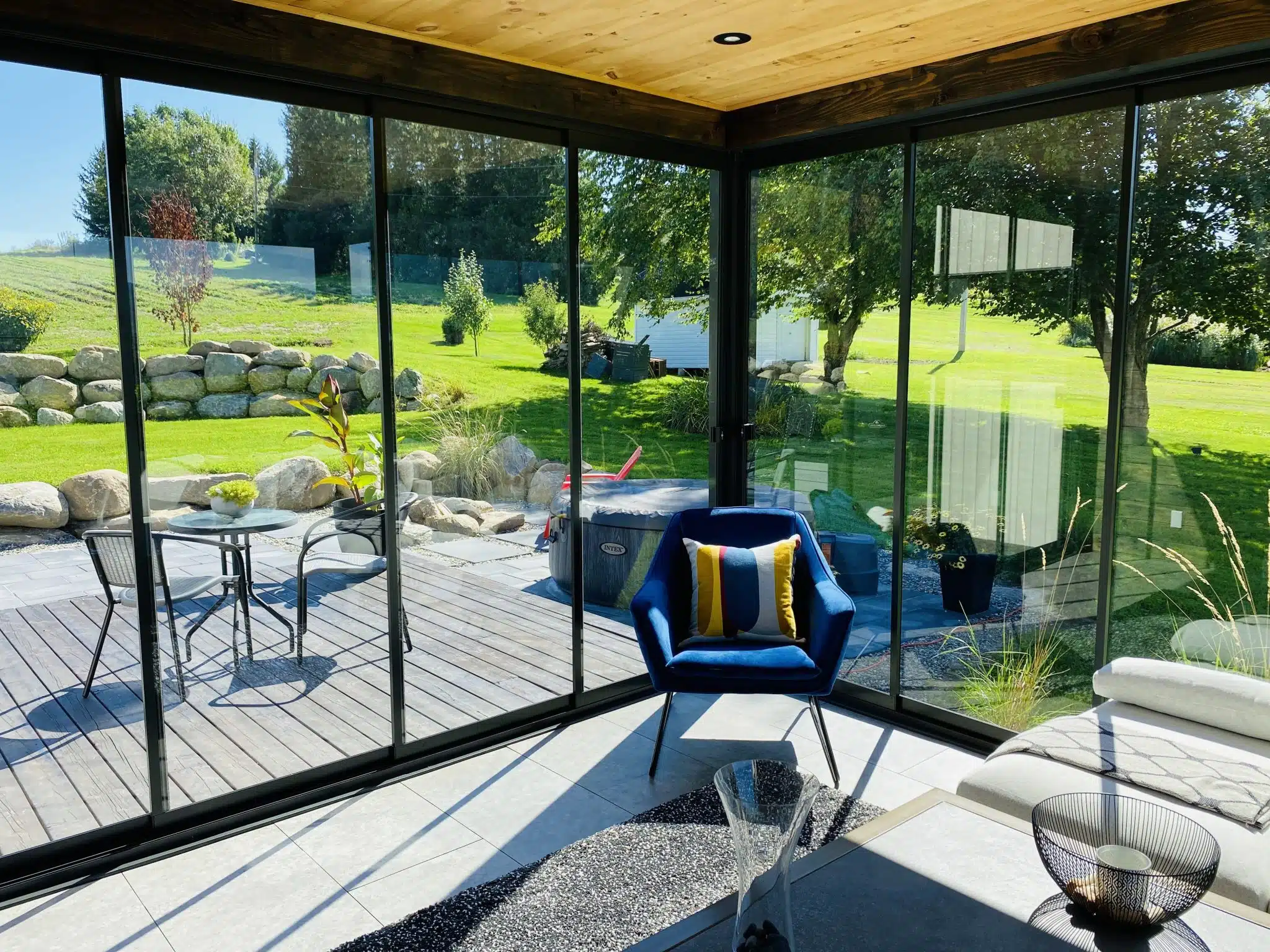 Patio with dining area enclosed by sliding glass panels