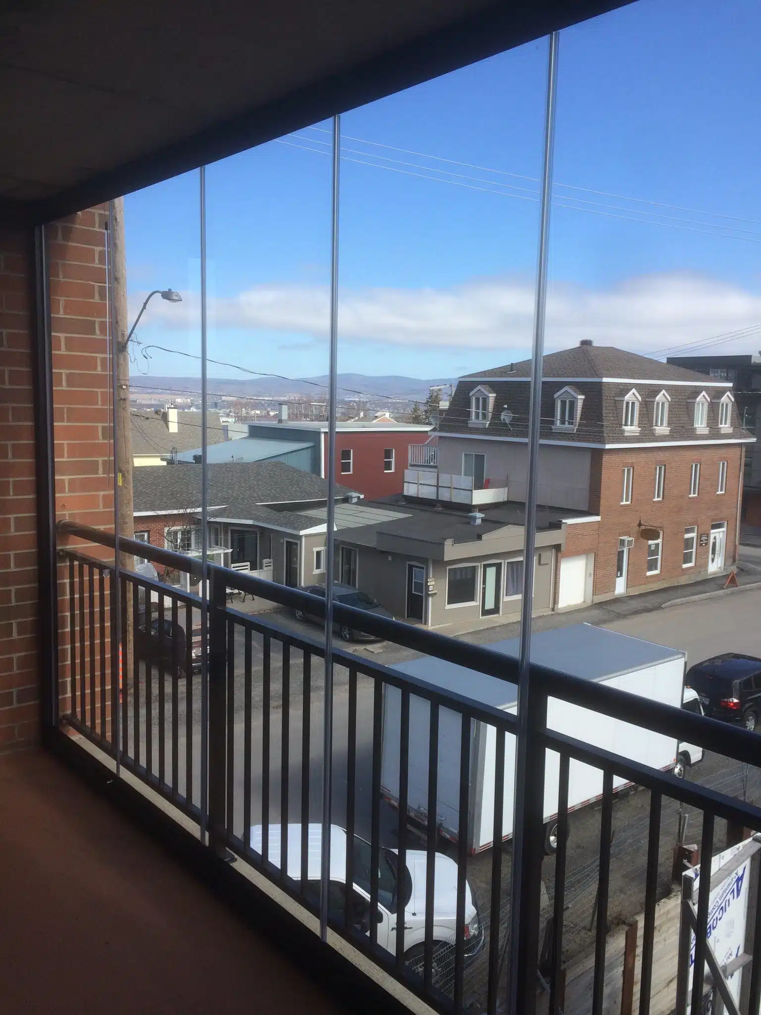 Urban balcony with sliding glass panels