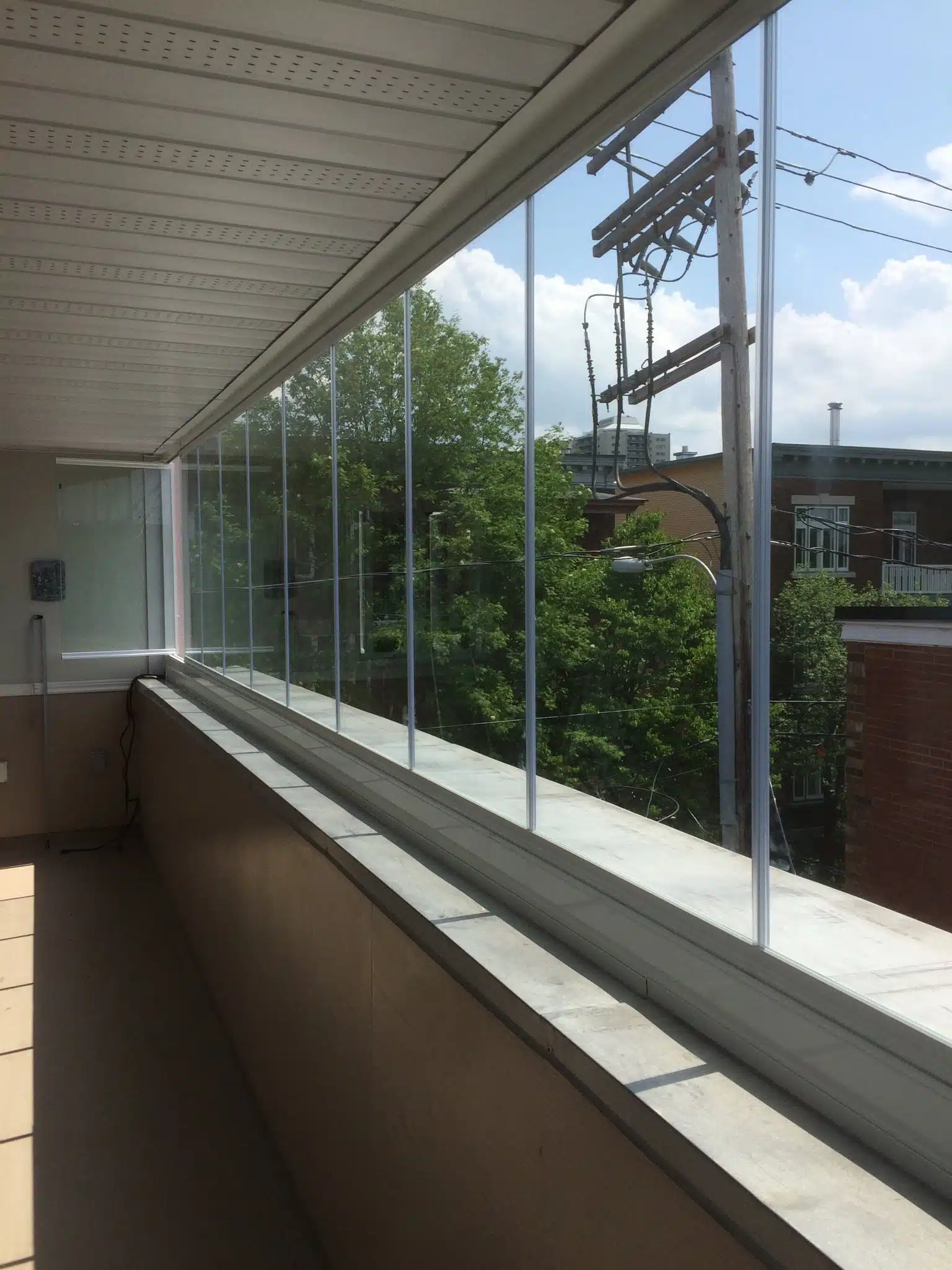Residential balcony enclosed with glass panels